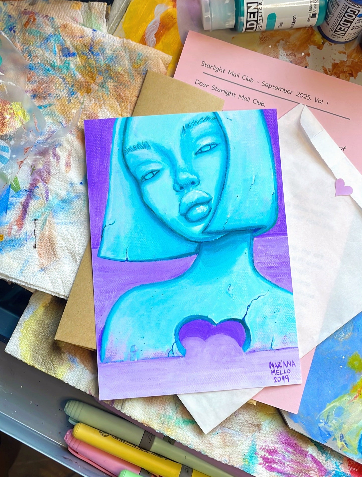 Artistic depiction of a face on a colorful background with art supplies around.