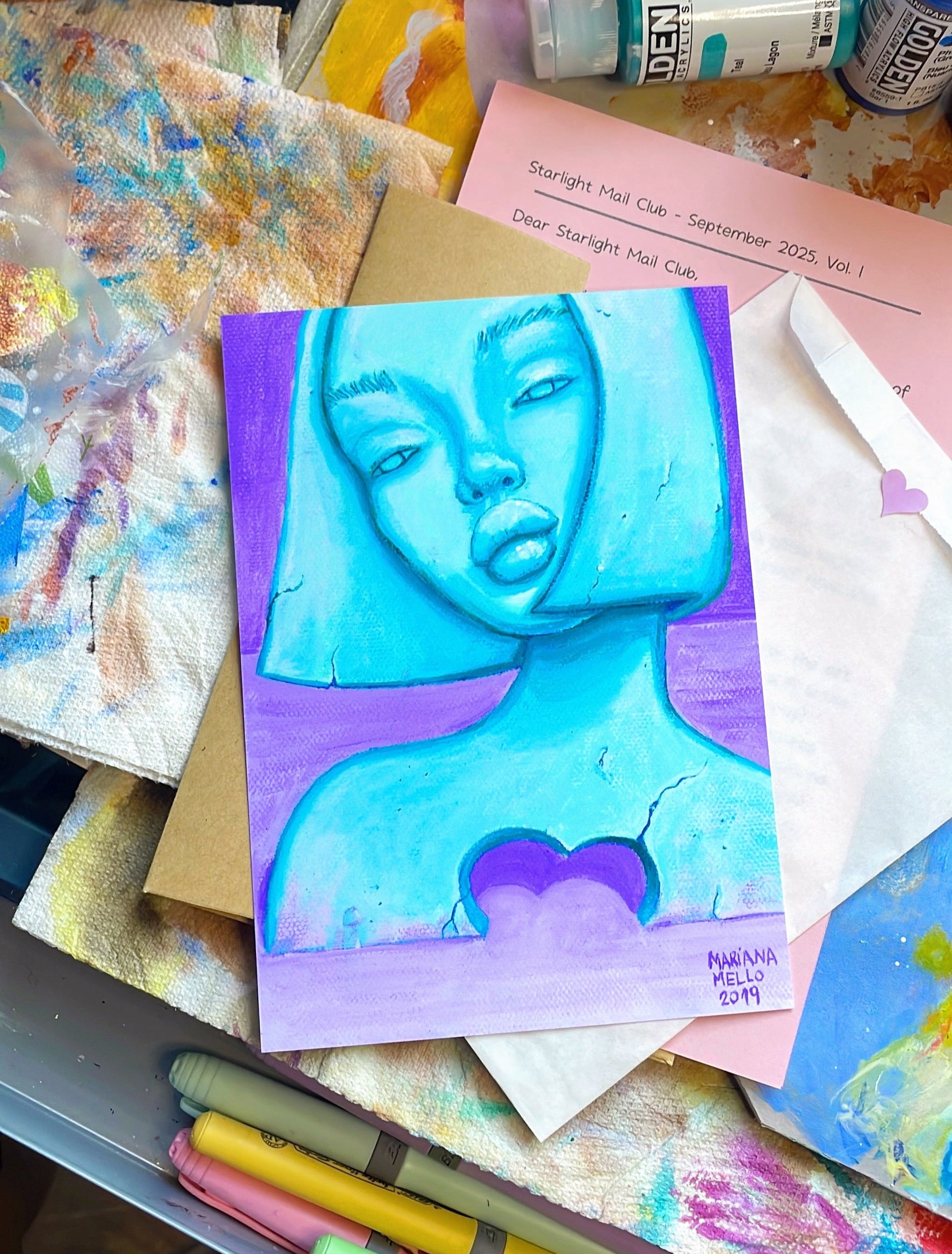 Artistic depiction of a face on a colorful background with art supplies around.